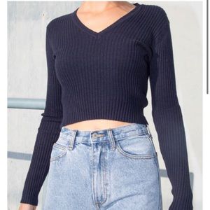 A dark blueish crop top sweater